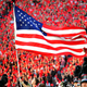 A member of the Georgia Bulldogs Cheerleaders takes the American flag to midfield as the team is introduced before the game against the Mississippi State Bulldogs at Sanford Stadium in Athens, Ga., on Sept. 23, 2017. (Scott Cunningham/Getty Images)